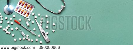 Pills, Ampoule, Syringes, Capsules, Stethoscope On The Green Doctor S Table. Copy Space. Place For T