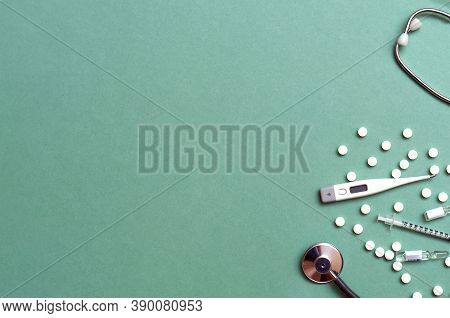 Pills, Ampoule, Syringes, Capsules, Stethoscope On The Green Doctor S Table. Copy Space. Place For T