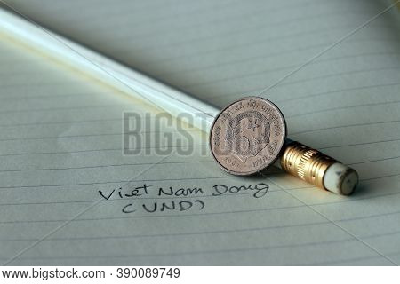 Two Hundred Vietnam Dong Coin On Obverse (vnd) With White Pencil On The Book.