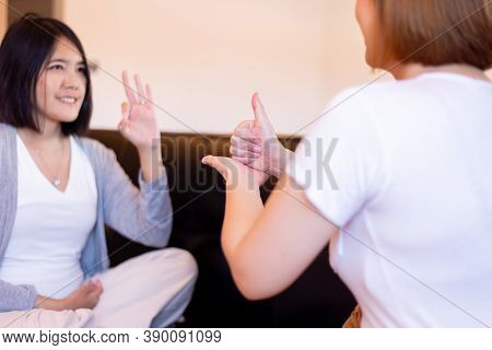 Sign Language Specialist Talking With Woman Patient Deaf Hearing And Showing Hands Gesture
