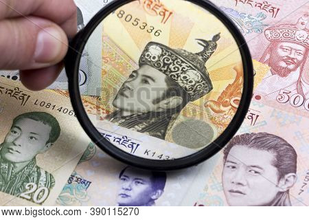 Bhutanese Ngultrum In A Magnifying Glass A Business Background