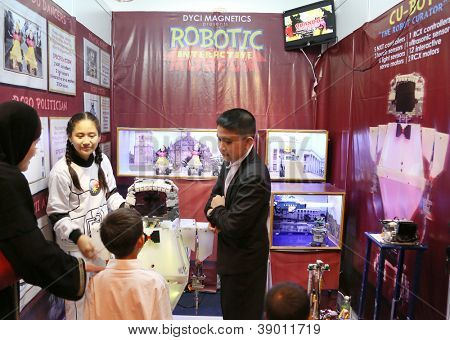 SUBANG JAYA - NOVEMBER 10: Unidentified high students from the Philippines explain their robotic project to visitors at the World Robot Olympaid on November 10, 2012 in Subang Jaya, Malaysia.