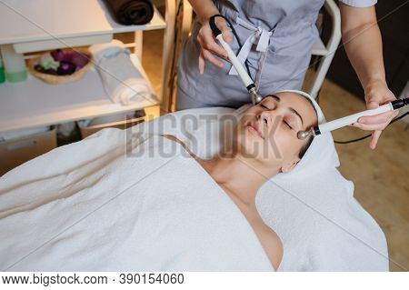 Lateral View Of Woman Facial Massage Spa Procedure. Electric Stimulation Facial Skin Care. Microcurr