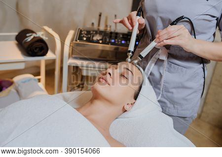 Lateral View Of Woman Facial Massage Spa Procedure. Electric Stimulation Facial Skin Care. Microcurr