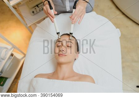 Woman Facial Massage Spa Procedure. Electric Stimulation Facial Skin Care. Microcurrent Lift Face. B