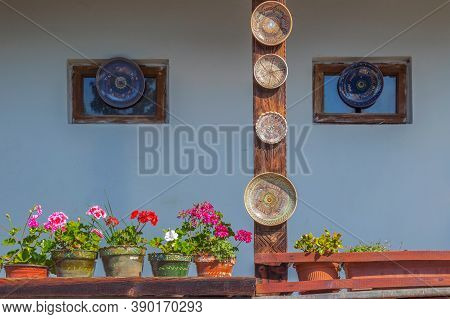 Romanian Traditional Ceramic Plates From Horezu Area, Romania, Placed Ornamentally On Rustic House W