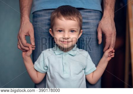 Portrait Of A Cute Little Baby Smiling Looking Up While His Father Hugs Him.happy Father With Son