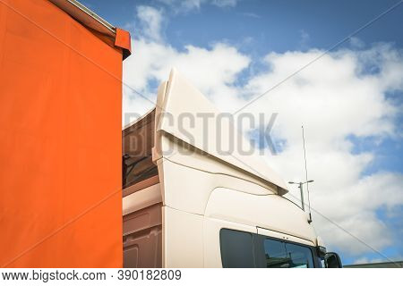 A Big White Truck Cabin View From Underneath Against The Sky