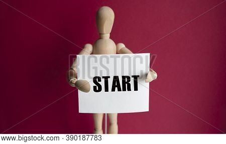A Wooden Man On A Red Background Holds A White Piece Of Paper With The Words Start The Content Of Th