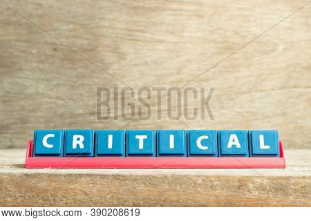Tile Letter On Red Rack In Word Critical On Wood Background