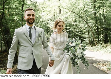 Just Married Couple Dancing Valse Outdoors, Free Space. Bride And Groom Hug, Blurred Green Grass Bac