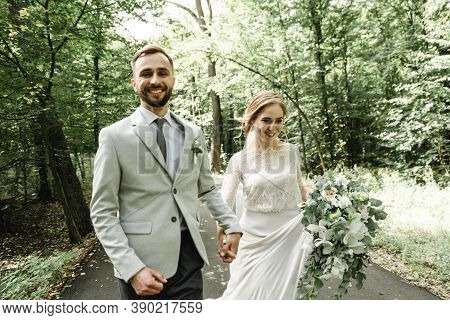Just Married Couple Dancing Valse Outdoors, Free Space. Bride And Groom Hug, Blurred Green Grass Bac