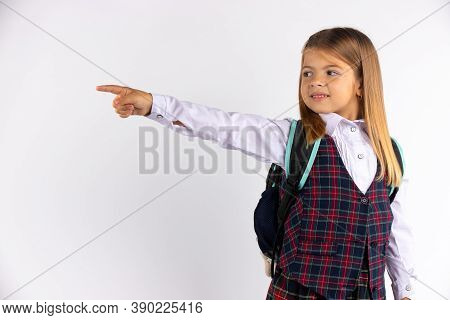 Attractive Smiling Little Blondine Customer With Long Hair Looking Sideways And Pointing Her Index F