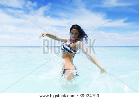 Vrolijke vrij jonge vrouw splashin in zee