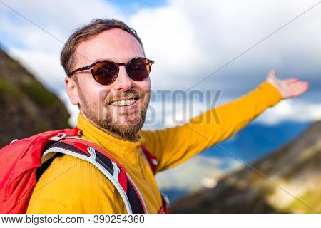Snow White Smiling Man With Braces In Mountains . Concept Of Teeth Care Far From Home