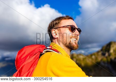 Snow White Smiling Man With Braces In Mountains . Concept Of Teeth Care Far From Home