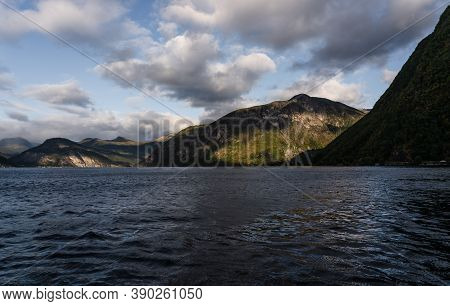 Travelling In The Fjord Between Linge And Eidsdal In Norway With High Mountains On The Sides Of The 