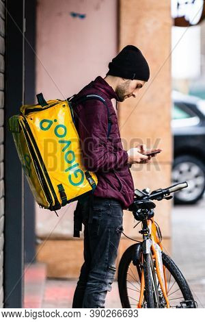 A Glovo Food Delivery Courier On A Bike. Restaurants Are Closed And Only Deliveries Are Allowed Duri