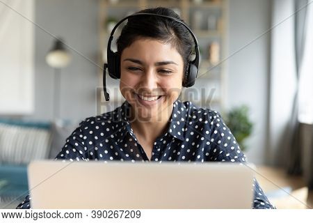 Indian Woman Wear Headset Looks At Laptop Talk By Videocall