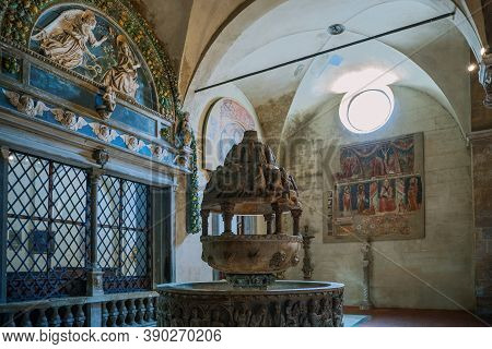 Lucca, Italy - June 5, 2018:   San Frediano Basilica, The Marble Baptismal Font Under The  Work In V
