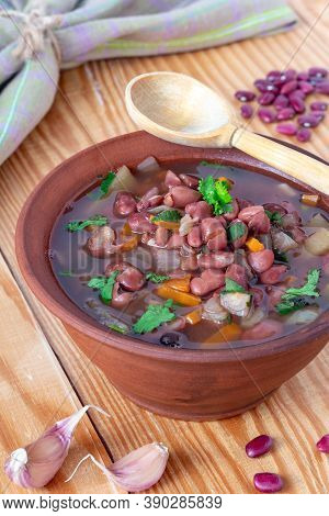 Bean Soup With Cilantro In Clay Plate On Wooden Background. Rustic Style. Vertical