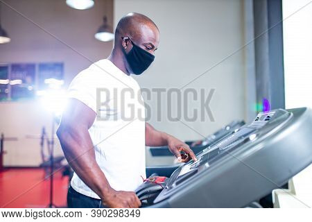 Spain Man In White Cotton T-thirt Wearing Mask While Working Out In Gym