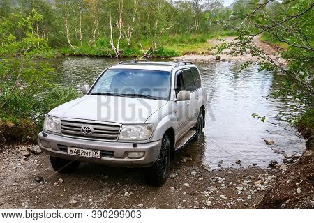 Murmansk Region, Russia - August 18, 2020: Expedition Car Toyota Land Cruiser J100 Crossing The Rive