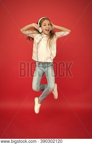 I Believe I Can Fly. Girl Listening Music Modern Gadget. Kid Happy With Wireless Headset Dancing Jum