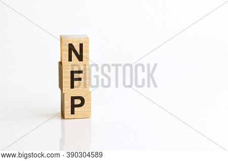 Three Wooden Cubes With Letters Nfp - Nonfarm Payrolls, On White Table, More In Background, Space Fo