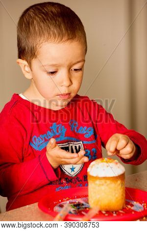 Young Son Teaches How To Decorate Easter Cake With Multi-colored Jewelry
