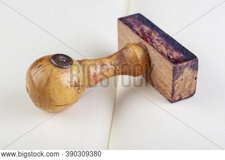 Old Wooden Seal. Stamp Used In Offices On A White Sheet. Light Background.