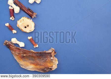 Variety Of Dog Treats. Dod Delicacy Food On Blue Background