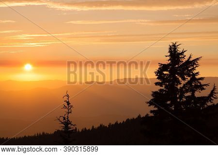 Thick Layers Of Smoke From A Nearby Forest Fire Turn The Suns Rays A Glowing Orange As It Sets Over 