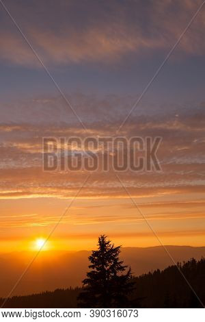 Thick Layers Of Smoke From A Nearby Forest Fire Turn The Suns Rays A Glowing Orange As It Sets Over 