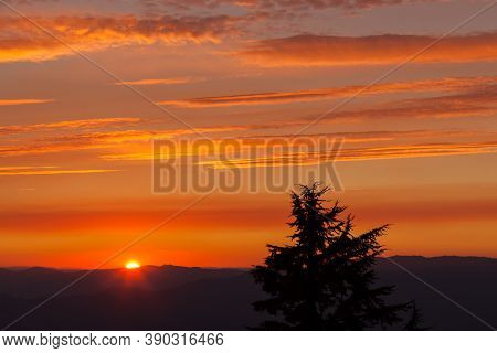 Thick Layers Of Smoke From A Nearby Forest Fire Turn The Suns Rays A Glowing Orange As It Sets Over 