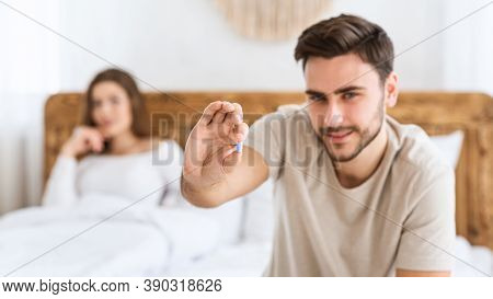 Mens Health And Sexual Problems, Male Power And Libido. Focus On Blue Pill In Hands Of Happy Young M