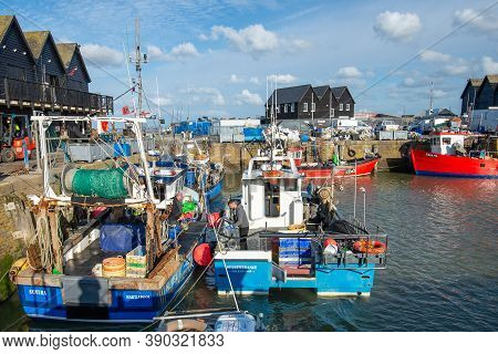 Whitstable Harbour, Kent, England - Oct 14 2020: Two Sea Fishermen Prepare Their Boats On A Bright S