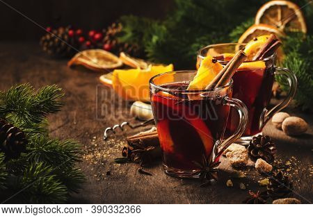 Xmas Hot Mulled Red Wine With Spices And Orange On Wooden Rustic Table. Traditional Christmas Or New