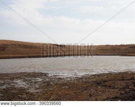 A Dramatic Landscape Of A Dry Lake. Dry Bottom Of A Dried-up Lake In Large Cracks. Conceptually: Env