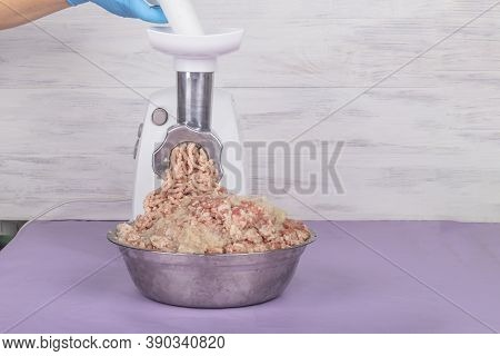 Electric White Meat Grinder. Minced Meat Is Wound And Lies In A Metal Bowl. Copy Space. Text.