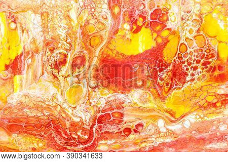 Motley yellow-red abstract background. Acrylic pouring. Hand drawn texture with cells