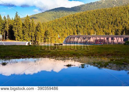 Bansko, Bulgaria Shiligarnika Autumn Ski Resort View With Mountains And Ski Lift Reflection In Puddl