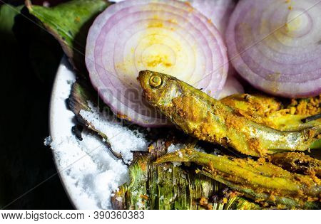 Cooked Indian Carplet Fish Or Mourala Fish With Onion Slices And Spices With Selective Focus