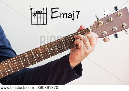 Learn Guitar - Man In A Dark Blue Shirt Playing Guitar Chords Displayed On Whiteboard, Chord E Major