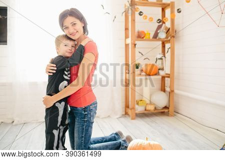 Happy Family Of Mother And Children Prepare For Halloween In Decorate The Home
