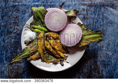 Indian Carplet Fish Or Mourala Fish  With Onion Slices In A Plate