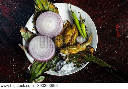 Closeup Of Cooked Indian Carplet Fish Or Mourala Fish With Spices And Onion Slices In A Plate Isolat