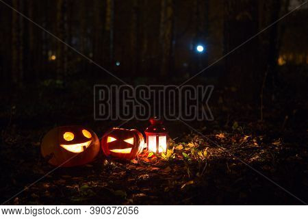 Pumpkin Lights With Candles On The Ground In A Park In The Light Of The Moon. Jack Olantern