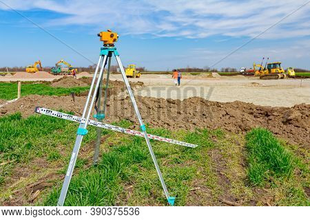 Surveyor Instrument And Leveling Lath Are Used For Measuring Level On Construction Site. Surveyors E