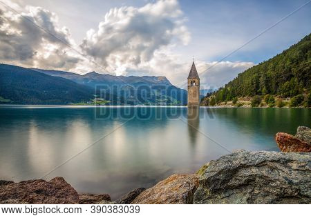 The Bell Tower Of The Sunken Church In Curon, Resia Lake, Bolzano Province, South Tyrol, Italy.